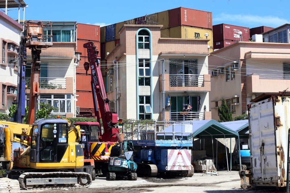 Containers stacked against houses in a Yuen Long village. Photo: SCMP