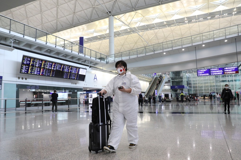 A traveller in full protective gear at the arrivals hall at Hong Kong International Airport. Photo: Winson Wong