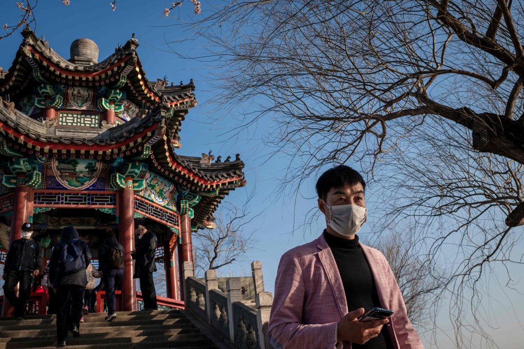 A man wearing a face mask as a preventive measure against the Covid-19 disease walks at the Summer Palace in Beijing, on Tuesday. China’s domestic travel is set to rise after authorities relax curbs imposed in the wake of the coronavirus outbreak. Photo: AFP