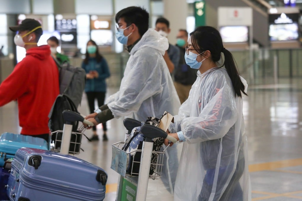 Well-protected travellers arrive at Hong Kong International Airport early on Thursday. Photo: Jonathan Wong