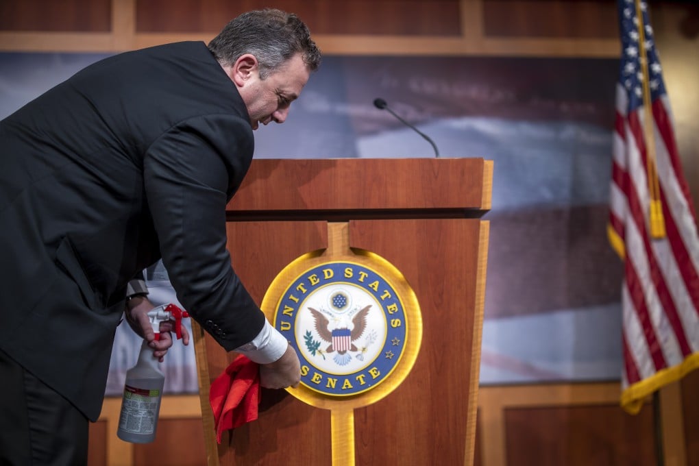 A US Senate lectern is sanitised before a press conference. Lawmakers passed a coronavirus economic stimulus package on Wednesday. Photo: EPA-EFE