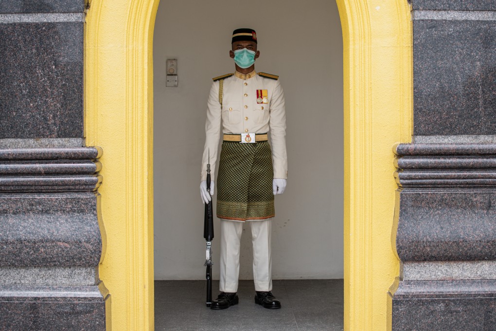 A Royal Malay Regiment Guard of Honour wears a protective face mask in Kuala Lumpur. Photo: AFP