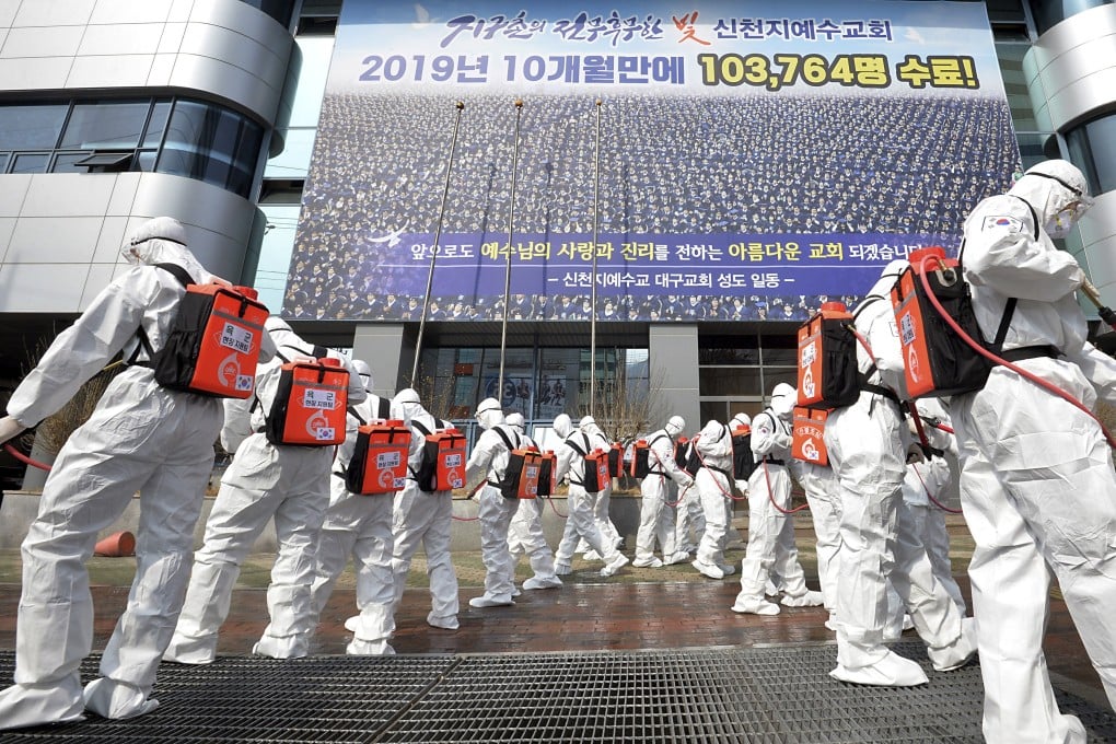 Army soldiers wearing protective suits disinfect a branch of the Shincheonji Church of Jesus in Daegu, South Korea. Photo: AP