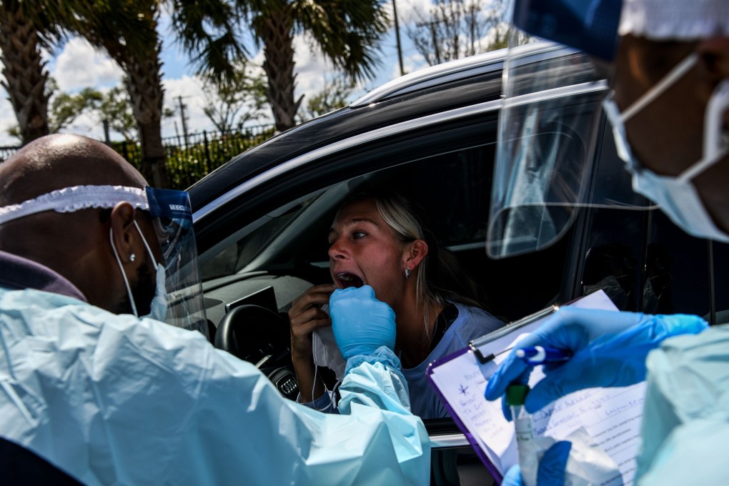 A US citizen attends a ‘drive-thru’ coronavirus testing lab in Miami. Photo: AFP