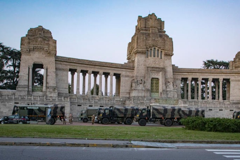 Italian military trucks and soldiers are seen by Bergamo's cemetery after the army was deployed to move coffins from the cemetery to neighbouring provinces. Photo: Sergio Agazzi/Fotogramma via Reuters