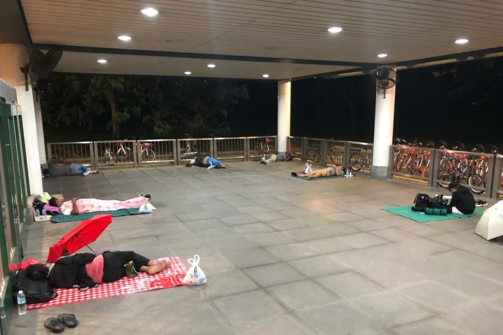 Malaysian workers seen sleeping behind the gates of Kranji MRT Station in Singapore. Photo: Today Online
