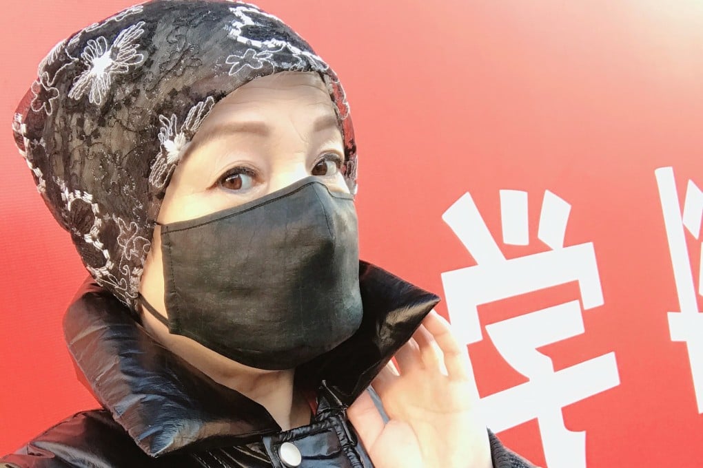 A woman wears a Kathrin von Rechenberg tea silk face mask in Beijing. The German fashion designer who is based in the Chinese capital used up scraps of silk from her studio making masks at a time when they were in short supply.