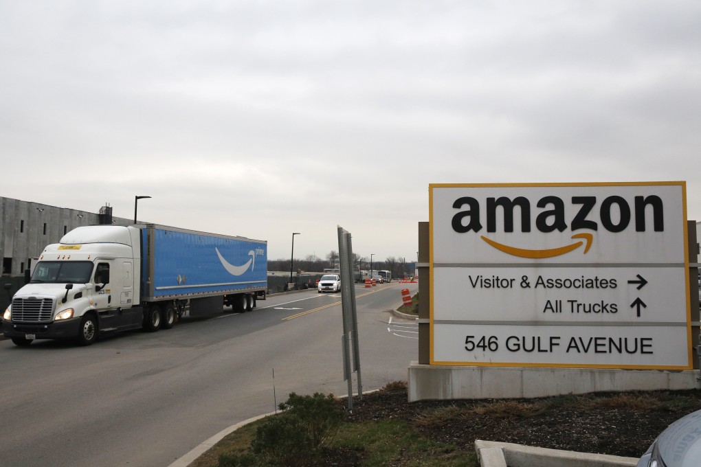An Amazon Prime truck passes by a sign outside an Amazon fulfilment center, Thursday, March 19, 2020, on Staten Island, in New York. Photo: AP
