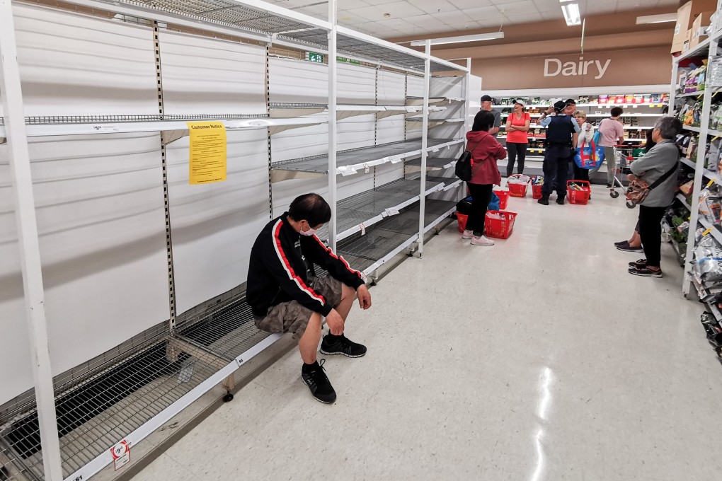 Shoppers wait alongside empty shelves for a delivery of toilet paper, paper towel and pasta at a supermarket in Sydney on March 20. Photo: EPA-EFE