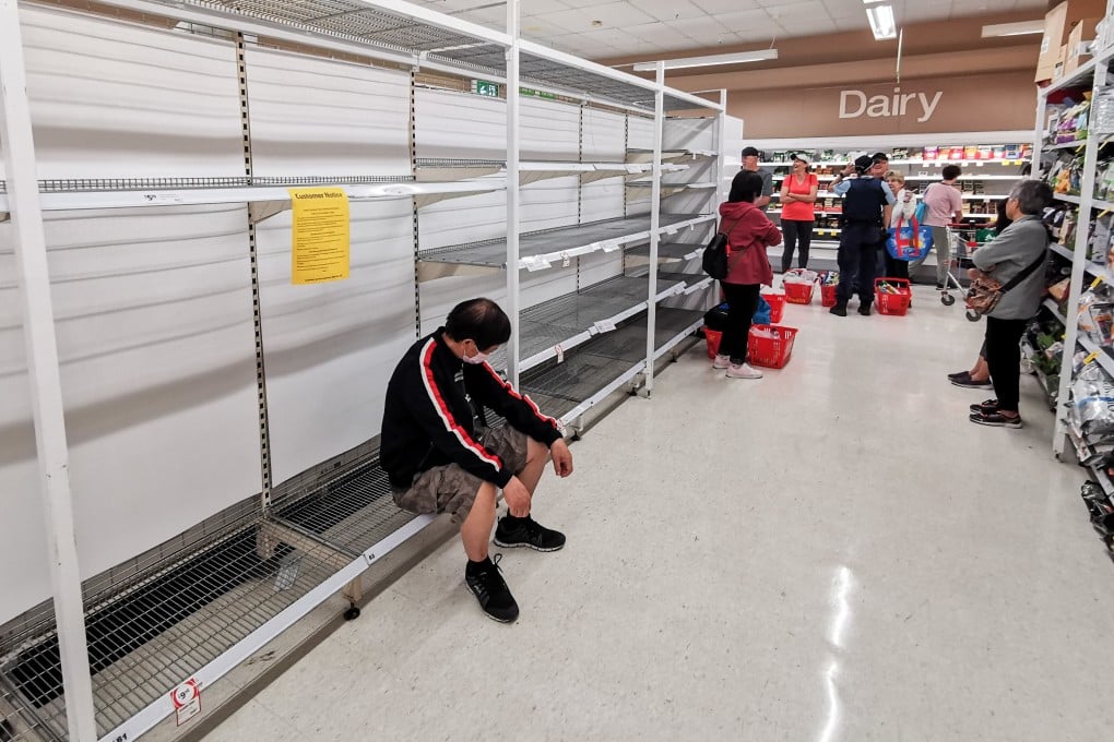 Shoppers wait alongside empty shelves for a delivery of toilet paper, paper towel and pasta at a supermarket in Sydney on March 20. Photo: EPA-EFE