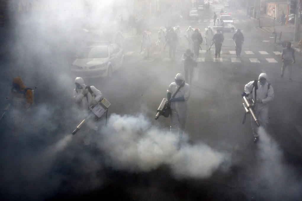 Iranian firefighters disinfect streets in the capital Tehran in a bid to halt the rapid spread of the coronavirus on March 13. Iran has reported over 18,000 cases of infection. Photo: AFP