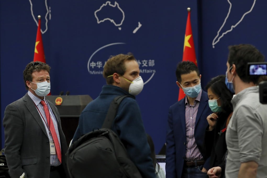 Foreign journalists chat after attending a daily briefing at the Ministry of Foreign Affairs in Beijing on March 18. At least 13 American journalists, from the New York Times, Wall Street Journal and Washington Post, stand to be expelled from China, including Hong Kong and Macau, in retaliation for a new limit imposed by the Trump administration on visas for Chinese state-owned media operating in the US. Photo: AP