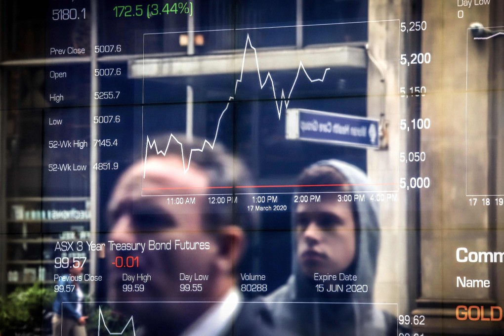 People are reflected in a window of the Australian Securities Exchange in Sydney on March 17. Asian markets have fluctuated after Wall Street suffered its worst day in more than three decades with coronavirus panic sweeping the globe. Photo: AFP