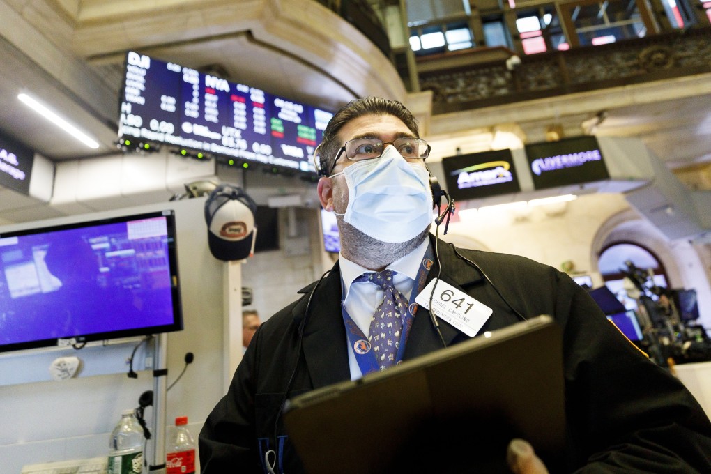 A trader wears a protective mask while working on the floor of the New York Stock Exchange on Friday. Photo: EPA-EFE