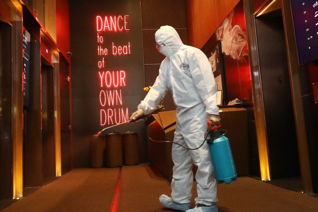 Cleaners move in to disinfect California Tower in the party hub of Lan Kwai Fong on the day dozens of new coronavirus cases took Hong Kong’s infected total above 250. Photo: Dickson Lee