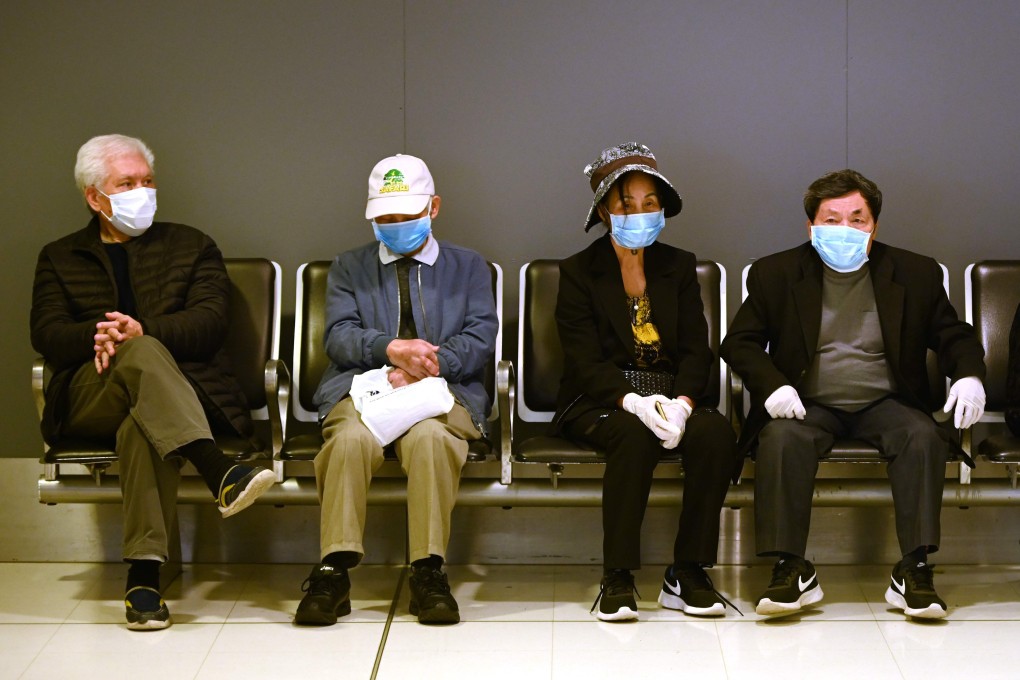 Passengers seen in face masks at the international airport in Sydney on March 18, 2020. Photo: AFP