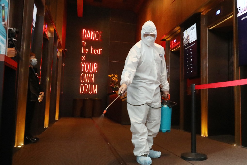 A cleaner disinfects California Tower in Lan Kwai Fong, Central, on March 20. Photo: Dickson Lee