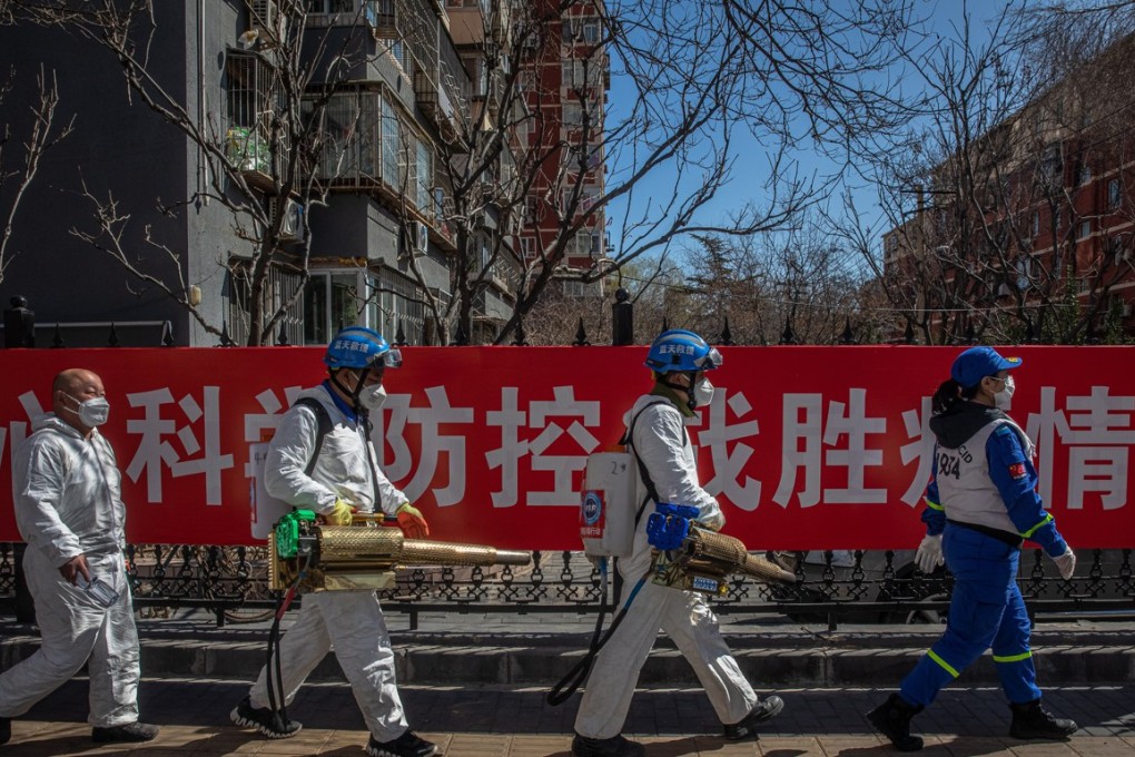 epa08291466 Members of the Blue Sky Rescue team walk with their equipment after disinfection of a residential area as a precaution against the spread of the coronavirus in Beijing, China, 13 March 2020. The World Health organization (WHO) officially declared the coronavirus outbreak a pandemic on 11 March 2020. EPA-EFE/ROMAN PILIPEY