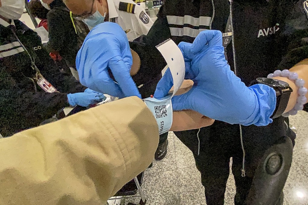 A passenger arriving into Hong Kong International Airport is one of the first to receive a tracking wristband on Thursday. Photo: Sam Tsang