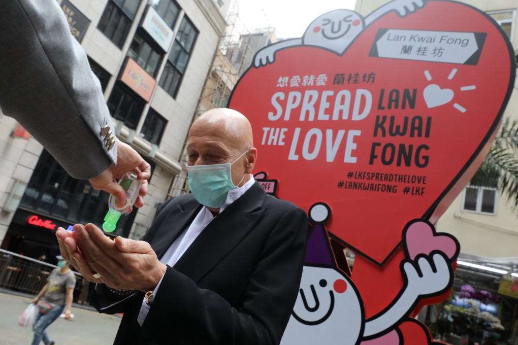 Allan Zeman, chairman of the Lan Kwai Fong Group, stands in front of a signboard promoting the nightlife district in Hong Kong’s Central district. Crowds were still thronging its bars, clubs, and restaurants last week, and others elsewhere, despite official calls to practise social distancing amid the coronavirus pandemic. Photo: Dickson Lee