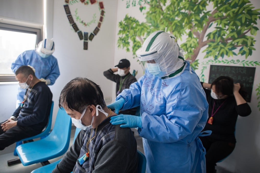 Medical workers massage patients' acupuncture points at the Wuhan pulmonary hospital in Wuhan. Photo: Xinhua