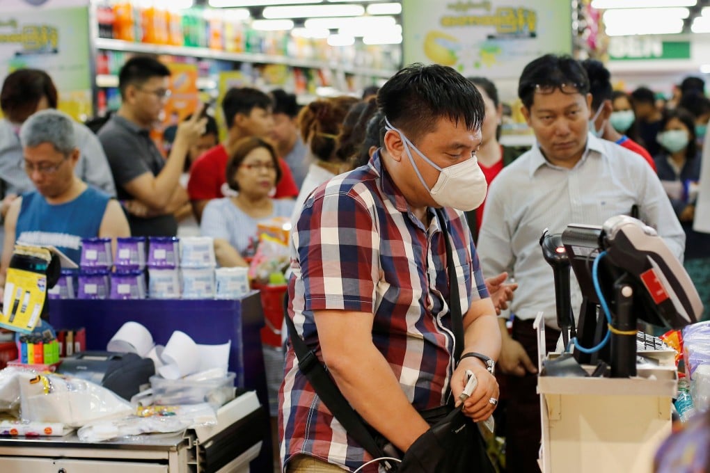 A crowd of people stock up at a supermarket in Myanmar. Photo: Reuters