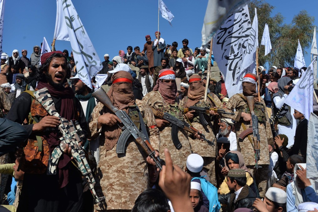 Afghan Taliban militants and villagers attend a gathering as they celebrate the peace deal with the US. Photo: AFP