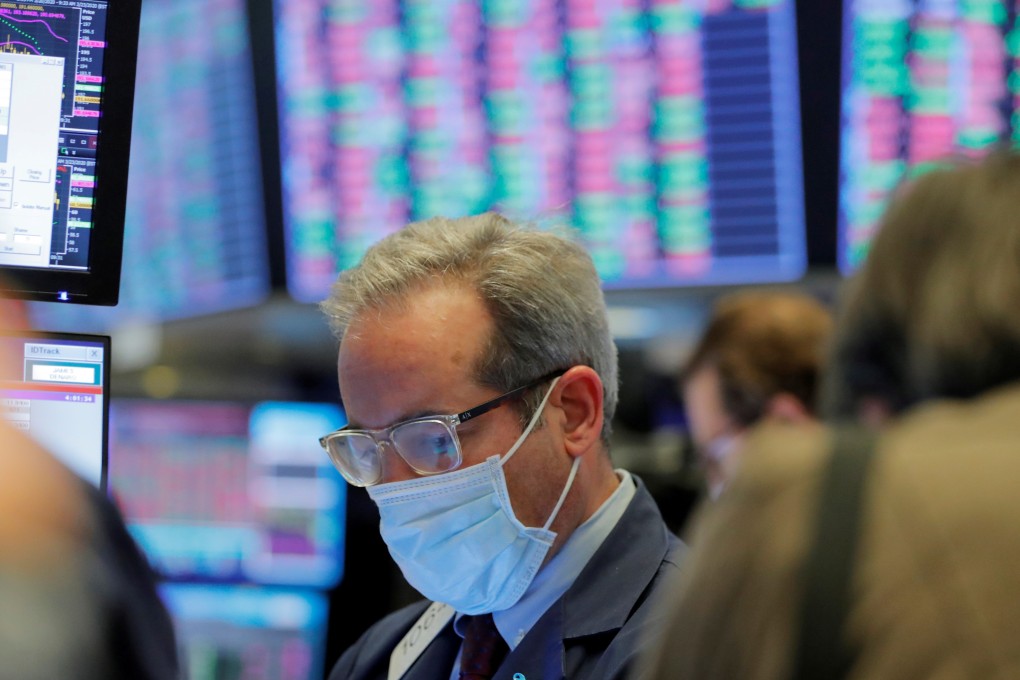 A trader wears a mask on the floor of the New York Stock Exchange on March 20 as the building prepares to close indefinitely due to the coronavirus outbreak. Photo: Reuters