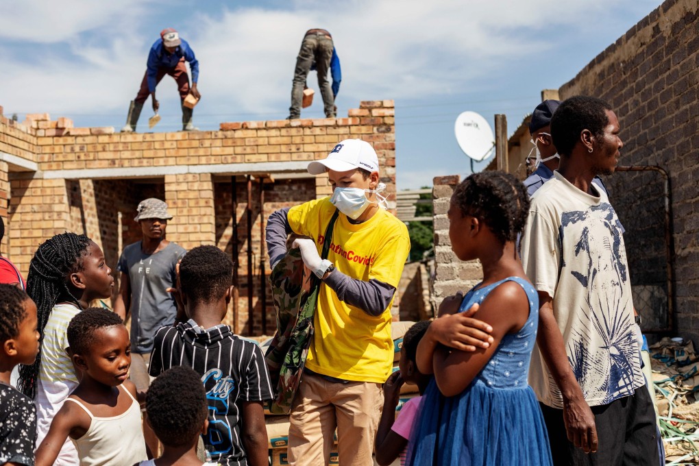 A volunteer distributes bars of soap in the Diepsloot township of Johannesburg on Saturday as concerns grow over the spread of the coronavirus. Photo: AFP