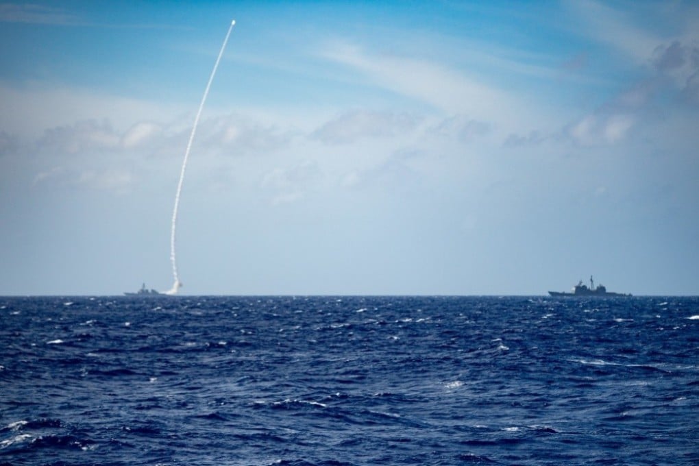 The guided-missile destroyer USS Barry (left) launches a missile during a live-fire exercise on Thursday. Photo: US Navy
