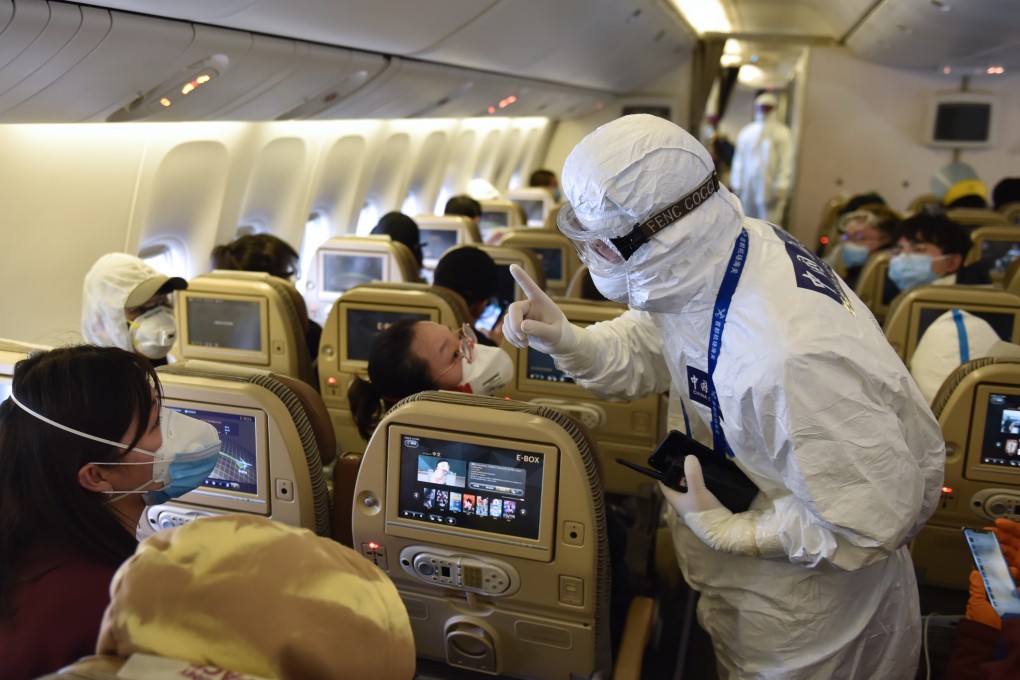 A customs officer speaks to passengers on board an inbound flight at Beijing Capital International Airport. Photo: Xinhua