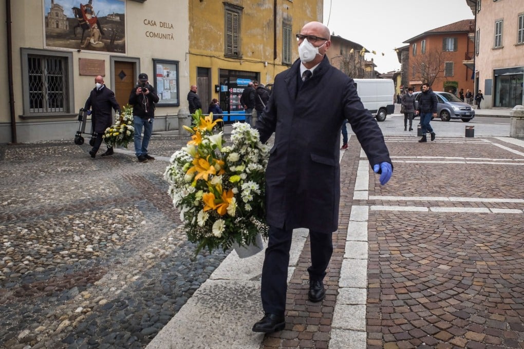 A mourner with a protective face mask attends a funeral service in Nembro, Italy, on March 7. The small town risks going down in history as having the highest percentage of victims in the coronavirus epidemic. Photo: EPA-EFE