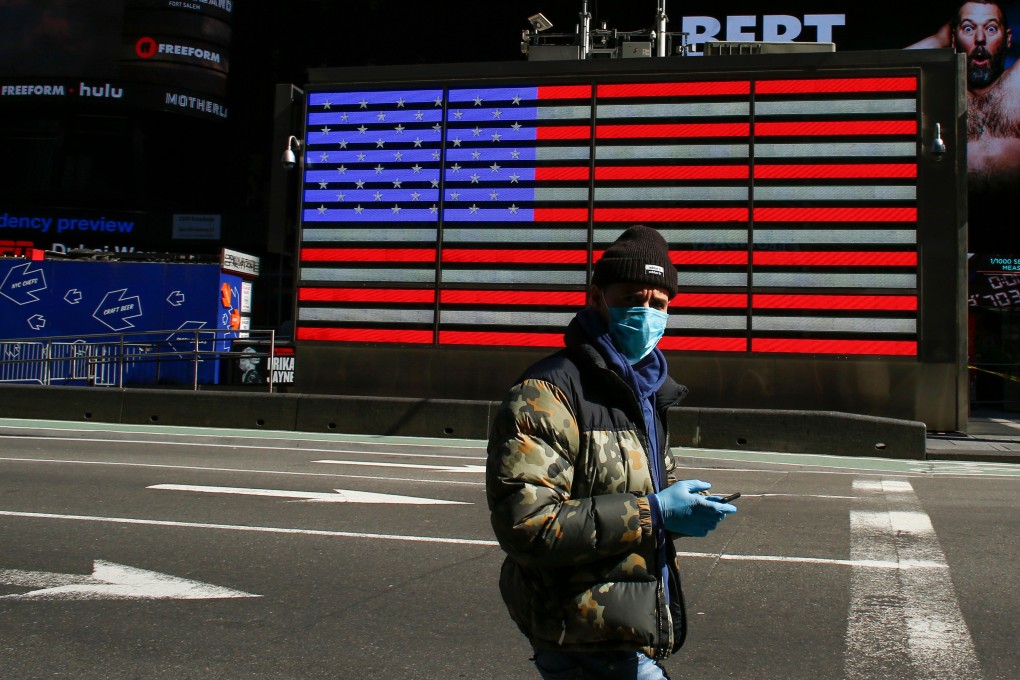 A man wearing a face mask in Times Square, New York City. Across Wall Street and the economic world, forecasters are quickly ramping up their predictions of massive job losses. Photo: AFP