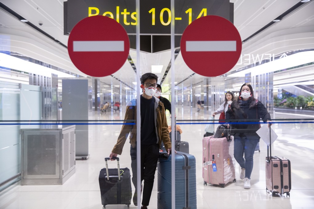 Travellers walk through arrival gates at the arrival hall of Changi airport in Singapore. Photo: EPA
