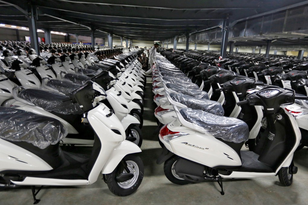 New scooters are lined up in a yard at an assembly line in a Honda manufacturing plant in Vithalapur, in the western Indian state of Gujarat, in June 2016. Photo: Reuters