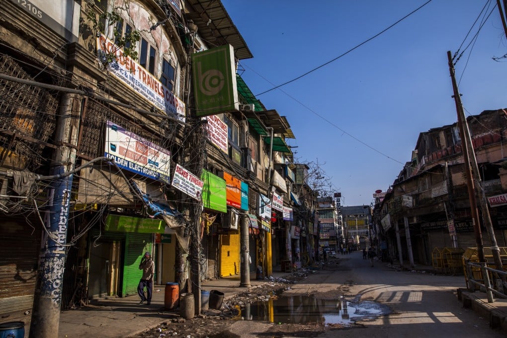 A man walks past closed stores near the Khari Baoli spice market in New Delhi on Sunday. Photo: Bloomberg