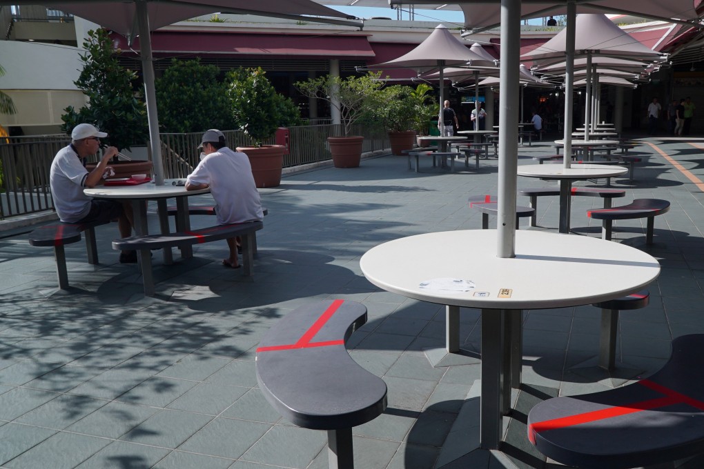 Seats are taped up to encourage social distancing at a food centre in Singapore. Photo: Reuters