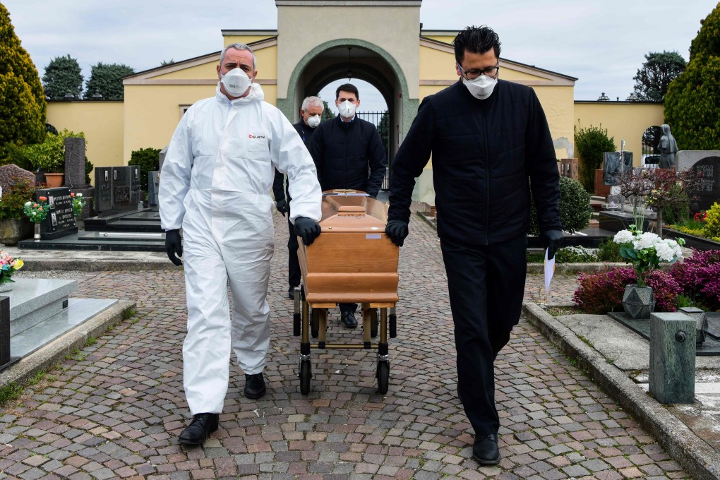 With relatives of the deceased in quarantine, there are only pallbearers at this cemetery in Italy’s Lombardy region. Photo: AFP