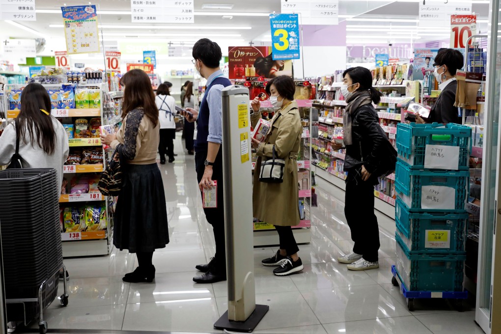 Japanese people queue at a pharmacy in Tokyo. Photo: Reuters