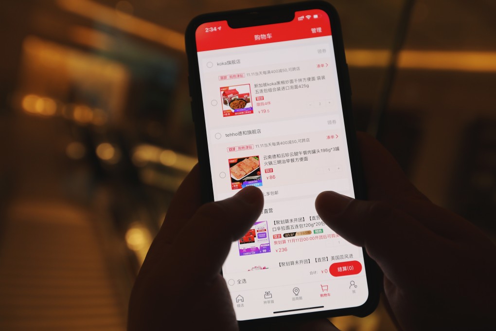 A man puts orders in his shopping cart on his mobile phone's Taobao app. Photo: SCMP
