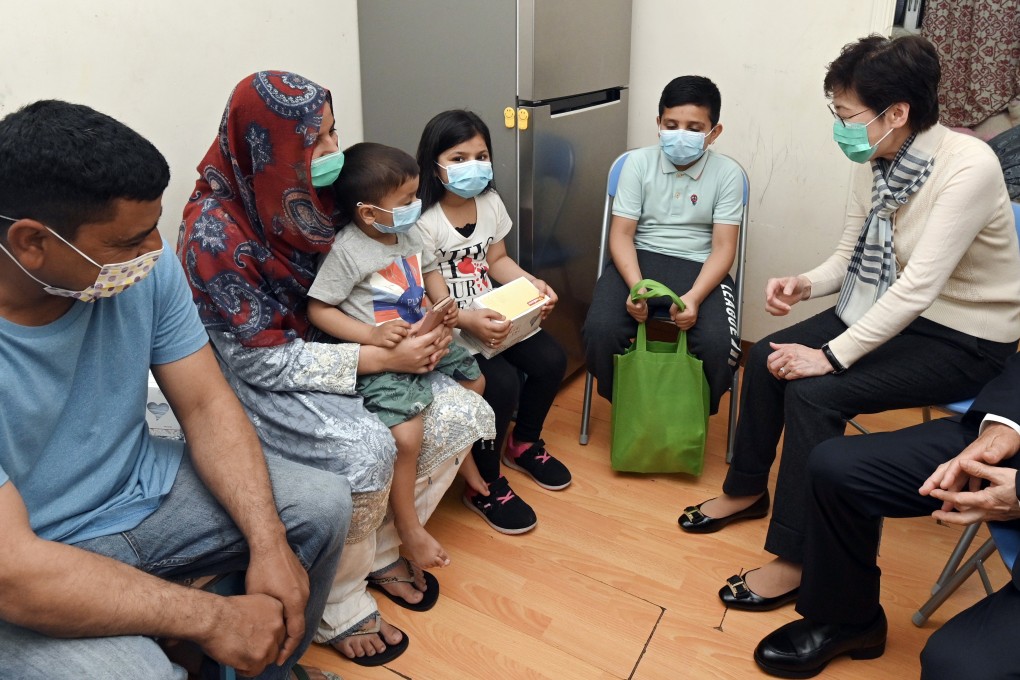 Chief Executive Carrie Lam Cheng Yuet-ngor visits ethnic minority families as part of a New Home Association activity to distribute face masks and other necessities, in Yau Tsim Mong district on March 1. Photo: ISD