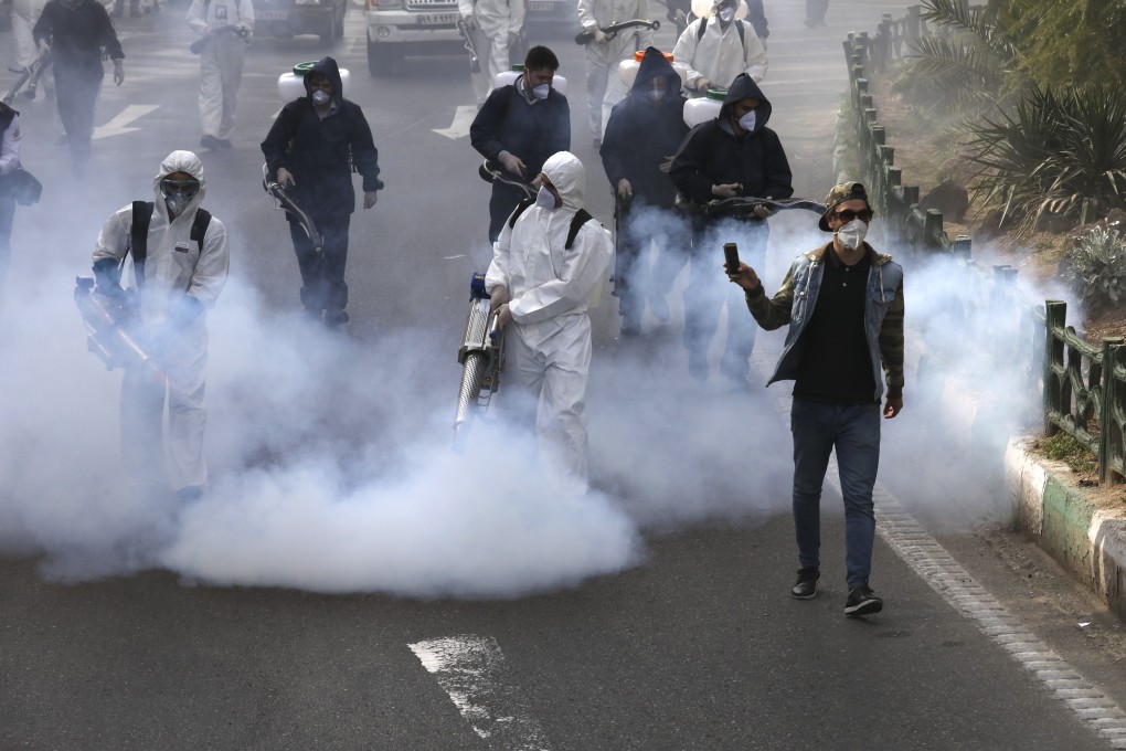 Firefighters disinfect a square against the new coronavirus in western Tehran, Iran. Photo: AP