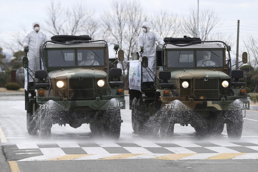 South Korean army trucks spray disinfectant as a precaution against the coronavirus on a street in Ulsan, South Korea, on March 3. Photo: AP