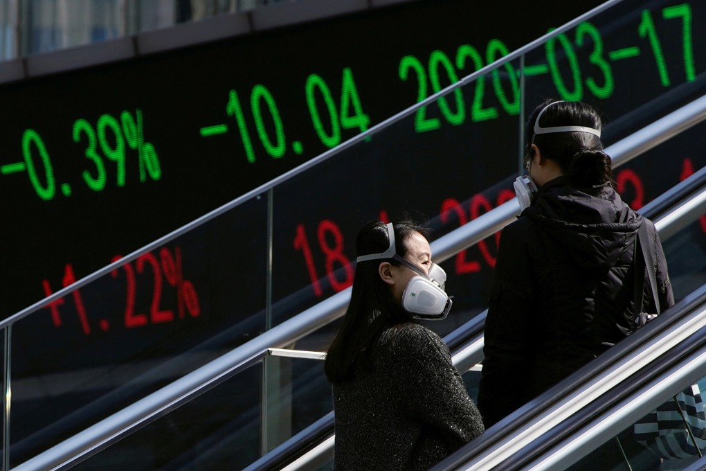 Pedestrians ride an escalator near an overpass with an electronic board showing stock information at the Lujiazui financial district in Shanghai on March 17. Photo: Reuters