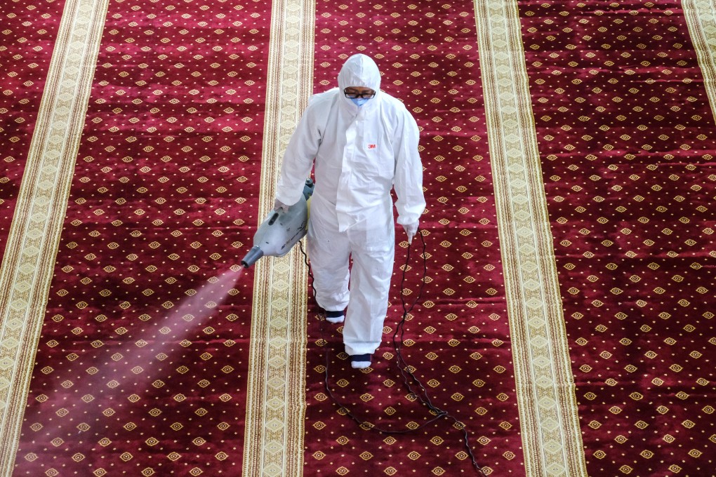 A worker disinfects a mosque near Kuala Lumpur, Malaysia, to guard against the coronavirus. Photo: Bloomberg