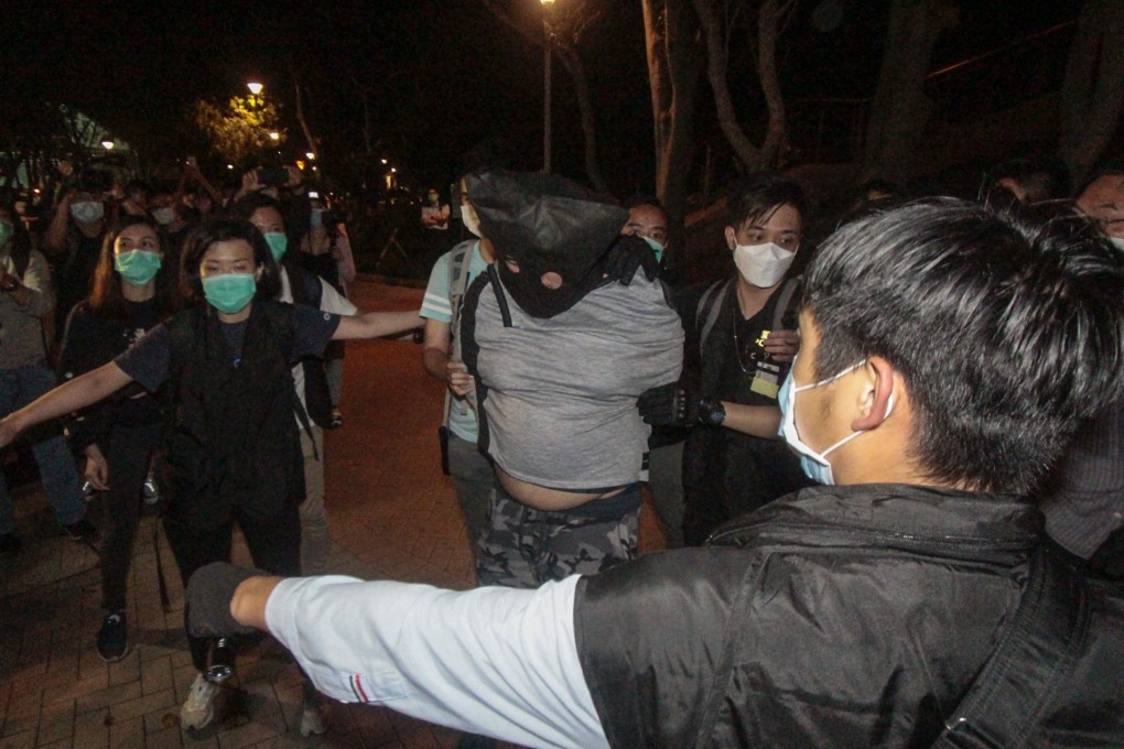 One of the suspects is led away by police. Photo: Handout