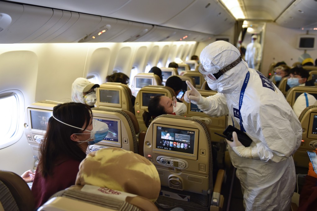 A customs officer serving inbound passengers on a flight at the Capital International Airport in Beijing on March 18, 2020. Photo: Xinhua