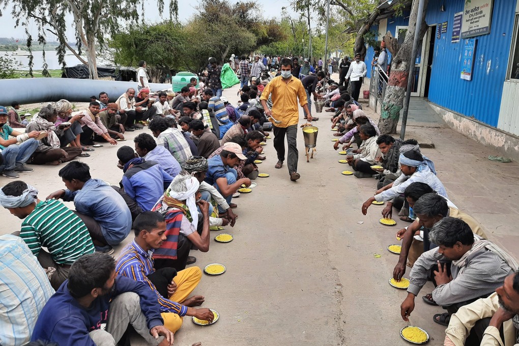 People receive food at a government shelter in New Delhi, after the lockdown to stem the spread of coronavirus meant many poor people were unable to make a living. Photo: AP