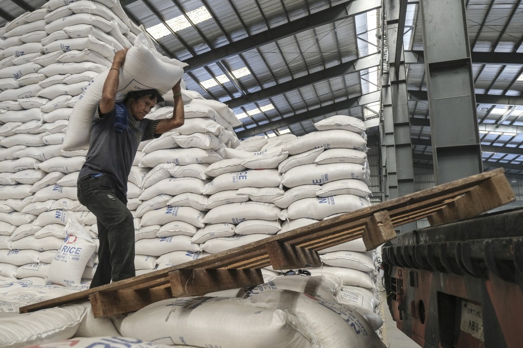 A worker carries a sack of rice inside a warehouse in Valenzuela, the Philippines. Photo: Bloomberg