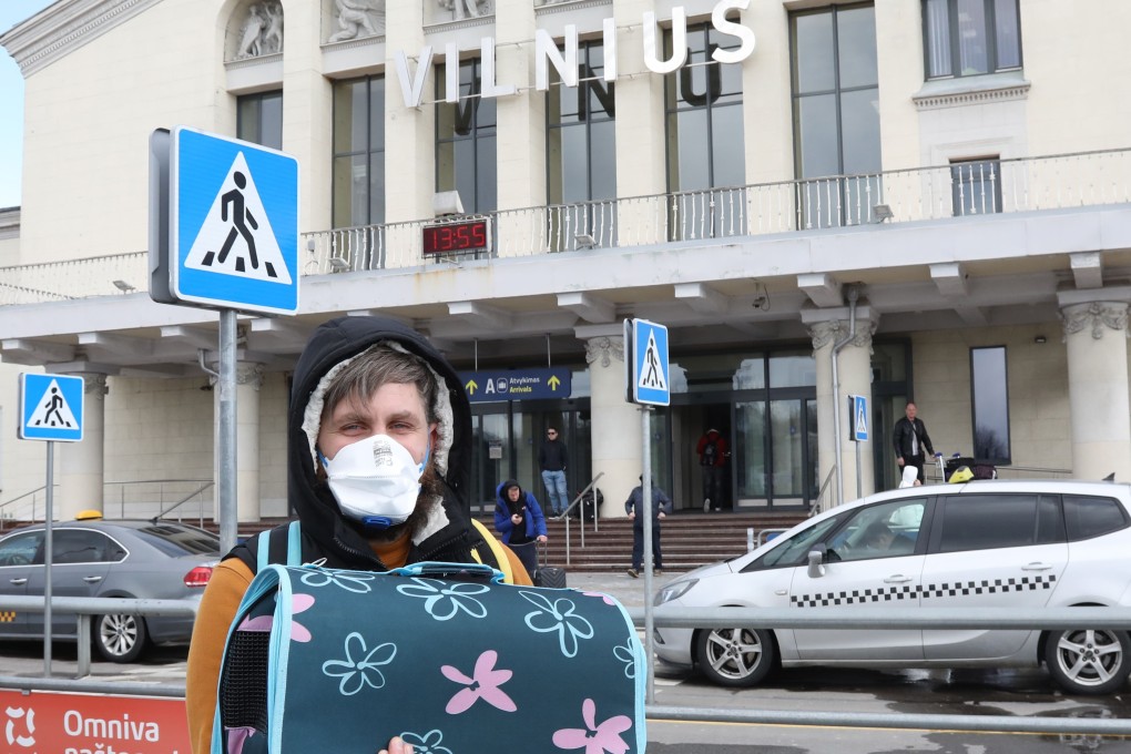 A masked traveller at Vilnius Airport, in Lithuania. Photo: AFP